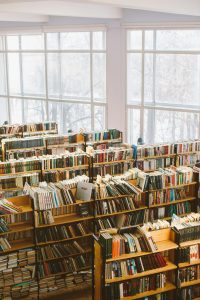 Spacious library room with bookshelves under natural daylight for study or research.